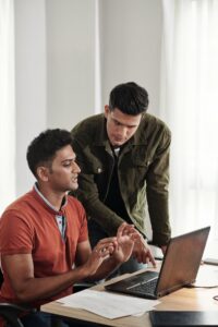 lead-developer-guiding-colleague_274689-34938