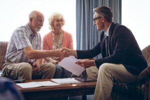 male-physician-interacting-with-senior-couple-retirement-home_13339-375437