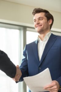 smiling-financial-adviser-handshaking-with-client_1163-5294